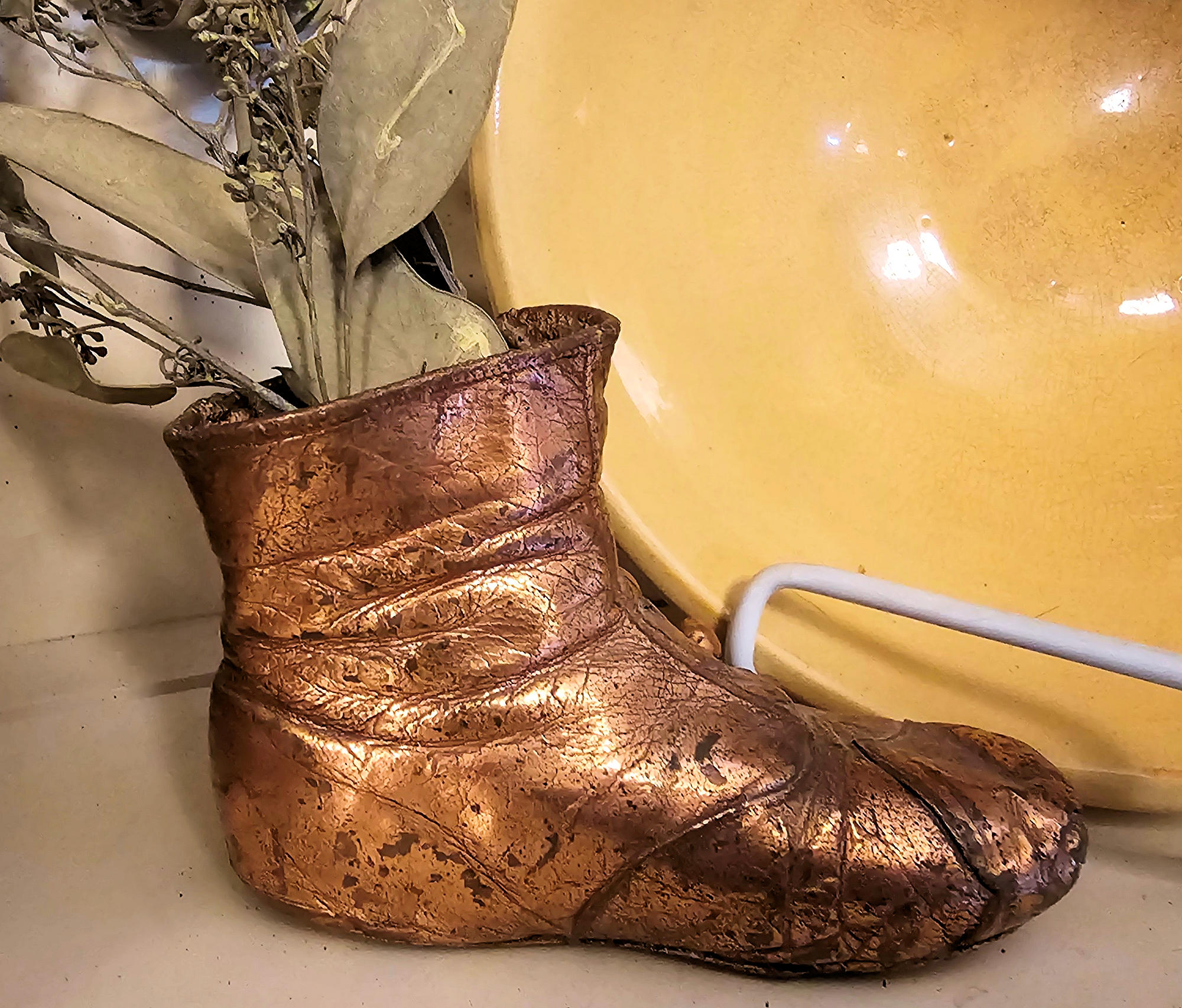 Antique bronzed copper coated Victorian button-up
baby shoe