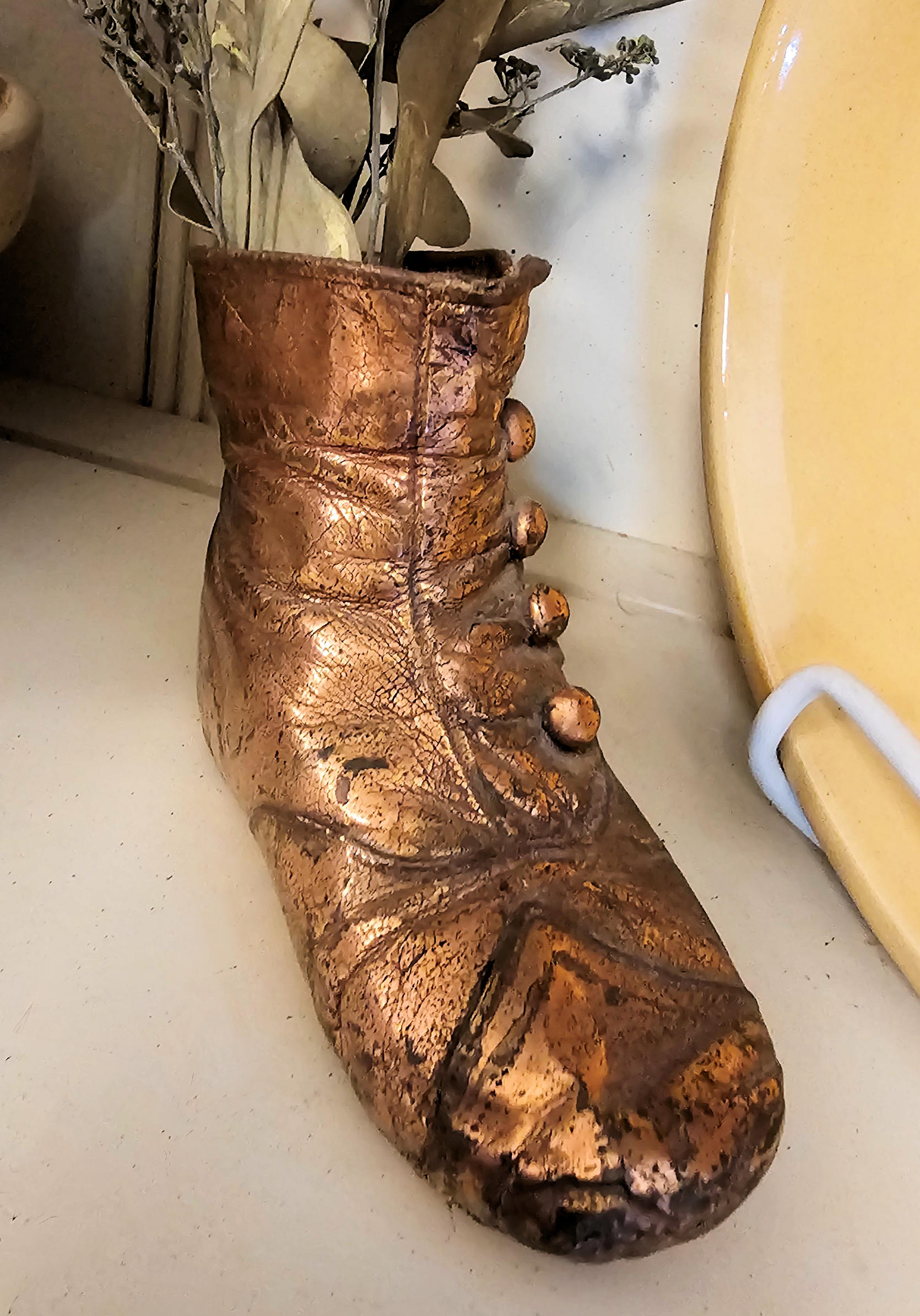 Antique bronzed copper coated Victorian button-up
baby shoe
