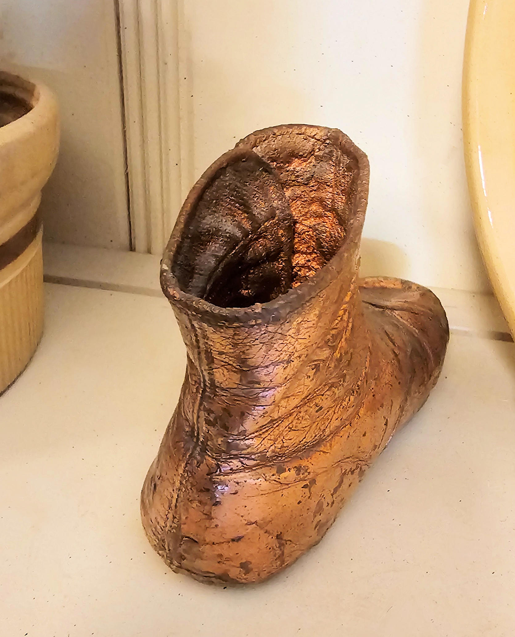 Antique bronzed copper coated Victorian button-up
baby shoe